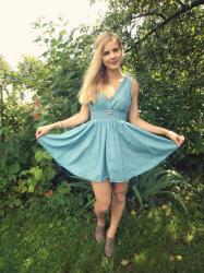 With blue dress in green grass.