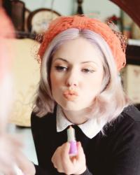 coral vintage hats with veils, lilac hair blackest eyeliner and peachy lips