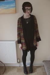 spider necklace and patterned cardigan