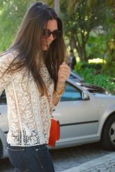 LACE TOP, JEANS AND AN ORANGE BAG