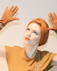 a vintage dress, a turban, a pair of vintage gloves, and... a deer