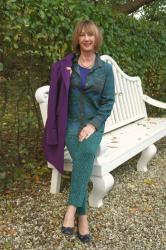A green outfit and a purple coat