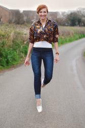A Knotted Patterned Shirt With Dark Skinnies & Two-Tone Loafers
