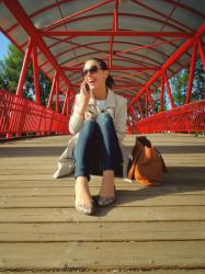 beige coat on red bridge