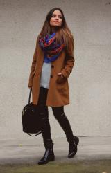 leather pants, long brown coat and colorful scarf