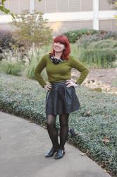 Outfit: Olive Green Sweater over a Floral Top, Pleated Leather Skirt, and Cutout Boots