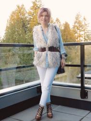 Overhead:  chambray shirt, white skinny jeans, lace-up shoes, and belted furry vest