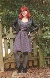 Outfit: Red and Green Plaid Dress, Faux Leather Jacket, Gray Tights, and Cat Eye Glasses