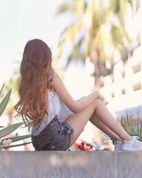 Long ombré hair, crop top, shorts, palm trees. Los Angeles...