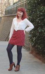 Outfit: White Lace Up Top, Red Geometric Floral Mini Skirt, and Tall Brown Ankle Boots