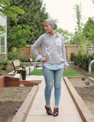 Star power: denim-on-denim jeans and shirt, star-patterned sweater, leopard heels, and floral beanie