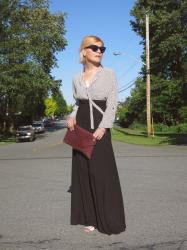 Time travel: black maxi skirt, dotted blouse, cat-eye sunglasses, and reptile envelope clutch