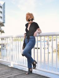 Oh Canada:  cropped flare jeans, wrap top, cut-out booties, and cat-eye sunglasses