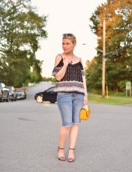 Shouldering on:  cold-shoulder blouse, boyfriend shorts, ankle-strap sandals and yellow mini-bag