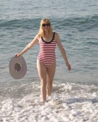 Red and White Striped Swimsuit, A Large Floppy Hat and A Nautical Raffia Beach Bag.