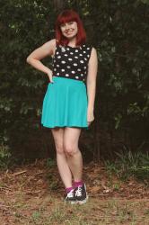 Outfit: Futurama Cat Pin, Dotted Crop Top, Colorful Skater Skirt, and Black Sneakers