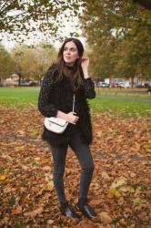 Outfit: all black outfit with star print blouse and shaggy faux fur vest