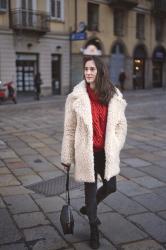 Red knit jumper and white furry coat