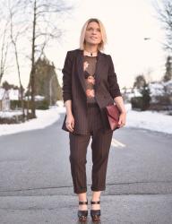 Suits me:  Styling a slouchy striped suit with a sheer top and platform heels