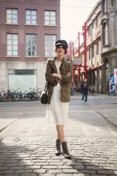 Outfit: military jacket, white lace dress and fiddler cap