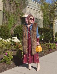 Gypset:  styling a floral maxi dress with a denim jacket, long fur vest, and ivory booties