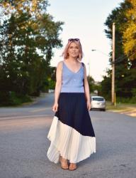 Glow:  styling a pleated, asymmetrical skirt with a knit tank top and strappy sandals 