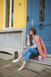 Outfit: embroidered jeans, pink coat, yellow wall