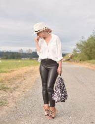 It's black and white: styling vegan leather leggings with an oversized shirt, straw fedora, and beaded sandals