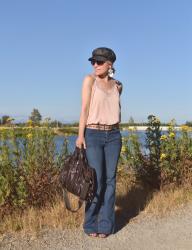 Happiness: flare jeans, lingerie-inspired camisole, and a baker boy cap