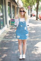 Denim Jumper with an Off-the-Shoulder Blouse + Sneakers.