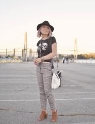 Tooth and Nail:  houndstooth trousers with a skull-patterned tee, open-toe booties, and a felt fedora