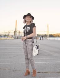 Tooth and Nail: houndstooth trousers with a skull-patterned tee, open-toe booties, and a felt fedora