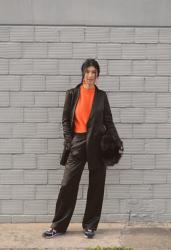 black suit & orange jumper