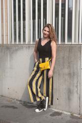 Striped pants and yellow belt bag at Milano Fashion Week