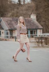 A Horse Coin Blouse With A Corduroy Skirt