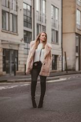 A Faux Fur Coat With Thigh High Boots