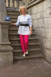 A pair of bright pink trousers, worn three ways