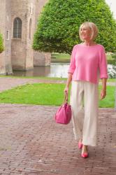 Pretty in pink: cream trousers and pink jumper