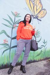 H&M orange sweatshirt and Femmeluxe Finery check pants.