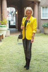 A yellow jacket with black leather trousers