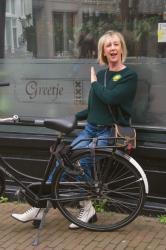 Dark green jumper with a light green brooch