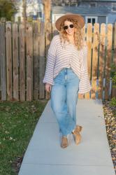 Striped Mocha and White Sweater + Wide-leg Jeans.