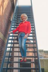 A red silk shirt with boyfriend jeans