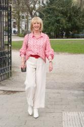 Red and cream shirt on cream trousers