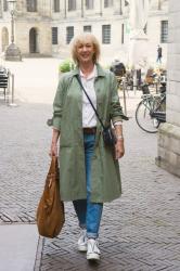 Walking through Amsterdam in a wide green trench coat