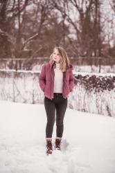 A Dusky Pink Puffer Coat In The Snow