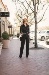 JUMPING INTO SPRING IN A BLACK JUMPSUIT