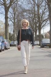 Navy blue jumper with cream trousers