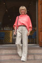 Pebble coloured trousers with a neon pink top