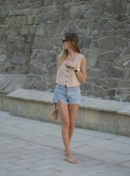 Beige vest and denim jeans